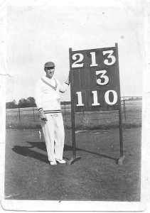 John Evans with cricket scoreboard (click to view larger photo
